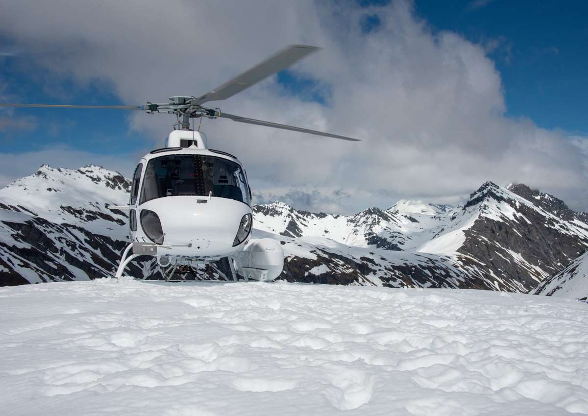Aspiring Helicopters helicopter parked on the snow at the glacier landing