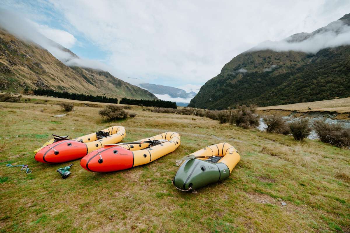 Packrafts laid out on the grass in the Matukituki Valley before the trip