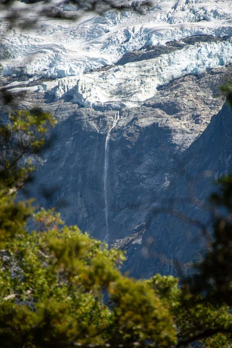 Rob Roy Glacier hanging above the West Matukituki Valley with waterfalls falling from the ice